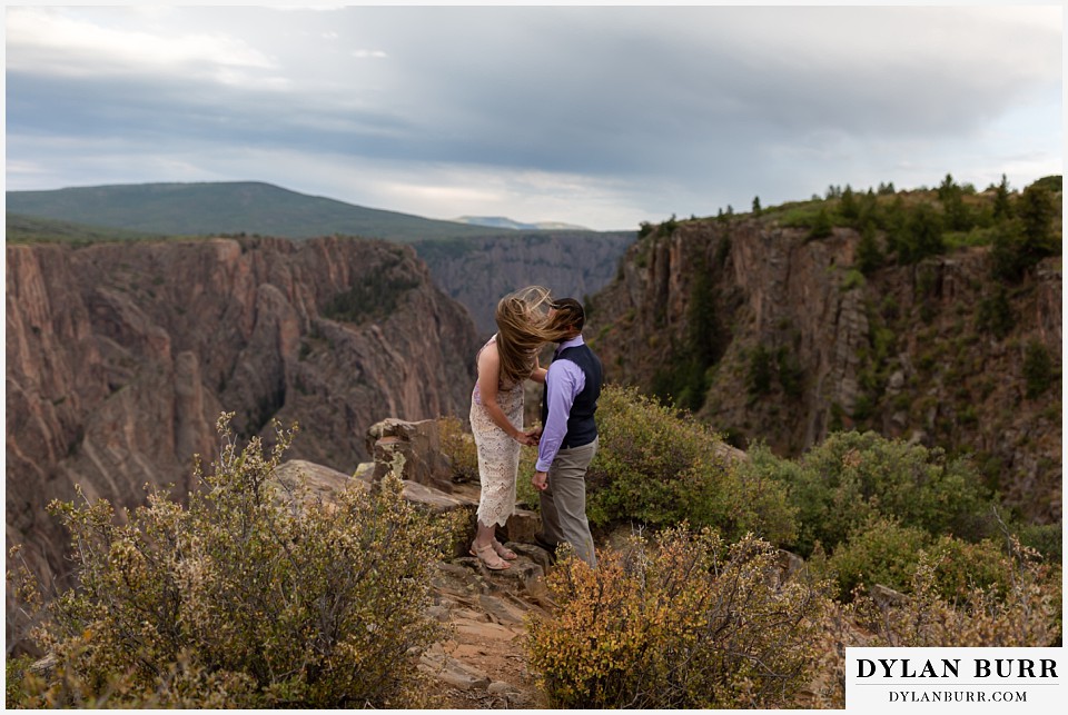 black canyon colorado elopement wedding adventure groom and bride with windswept air