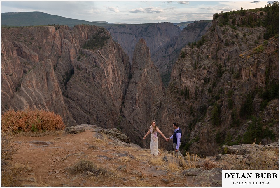 black canyon colorado elopement wedding adventure bride and groom walking along canyon wall