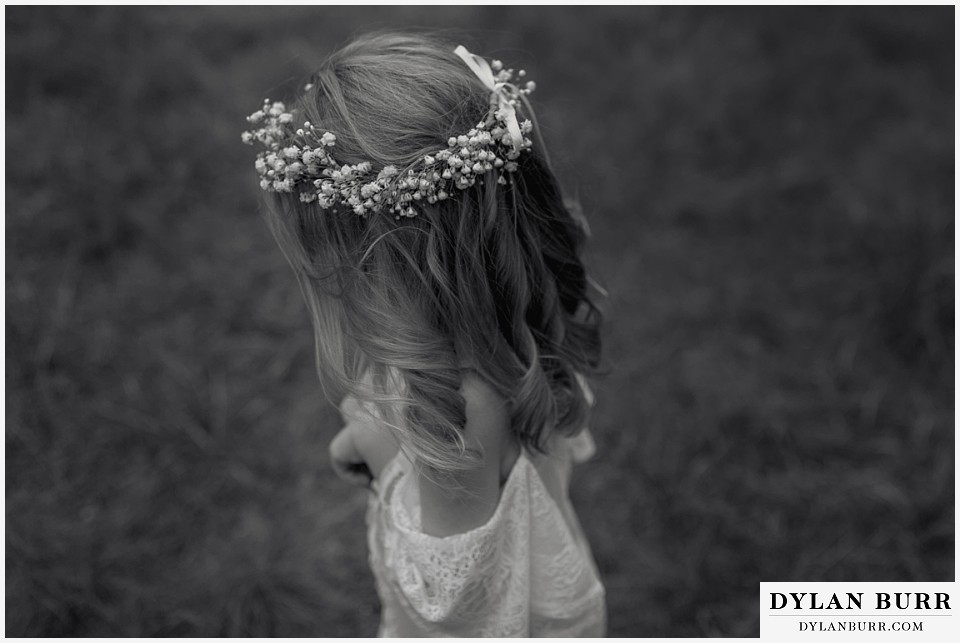 boho backyard colorado wedding black and white photo of little girls flower crown