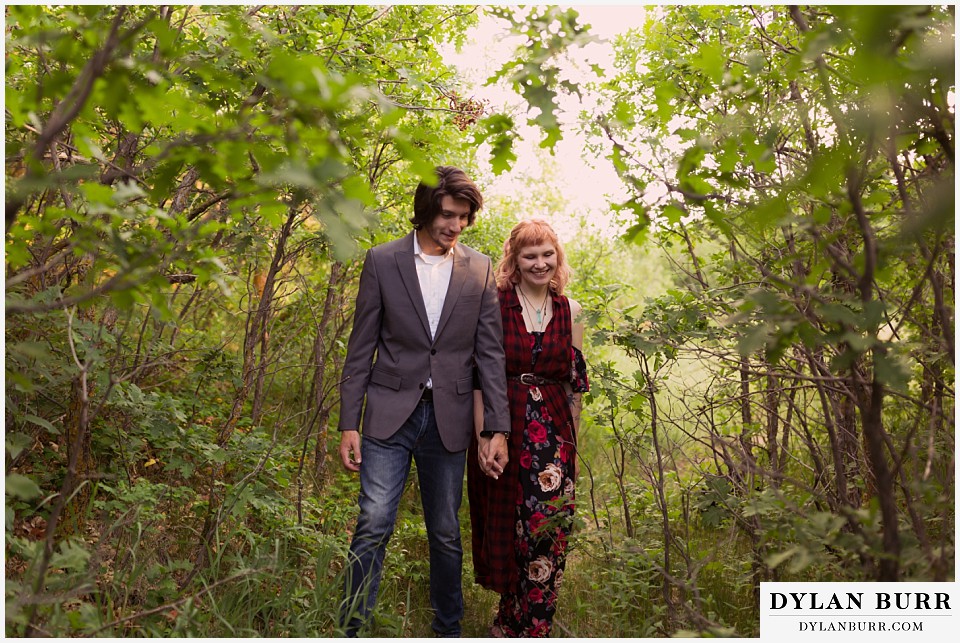 castle rock colorado engagement session walking in tight tree lined trail