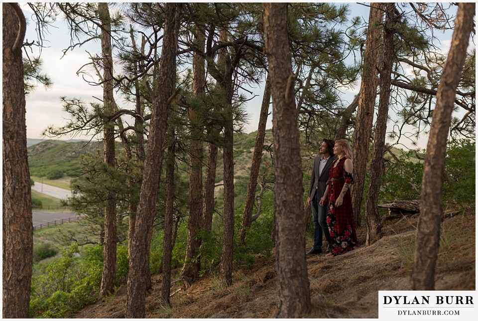 castle rock colorado engagement session watching sunset in pine trees