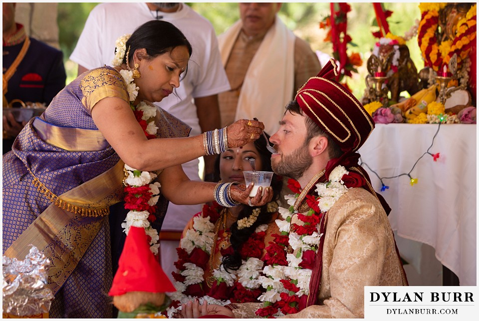 cielo at castle pines wedding colorado mountain wedding bride giving groom milk during hindu ceremony