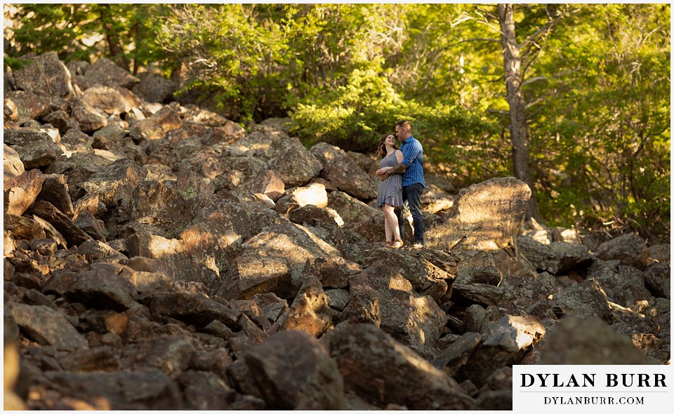 golden colorado mountain enagagement photo session couple together in a huge boulder field