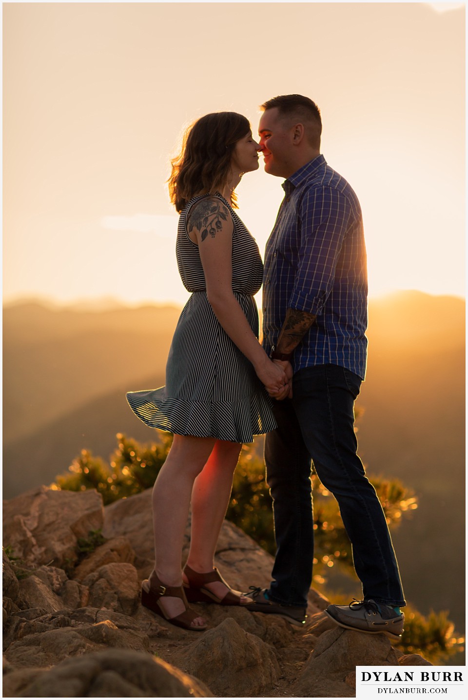 golden colorado mountain enagagement photo session couple in super close with sunset glow