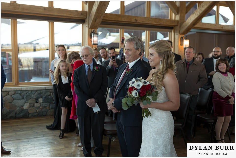 devils thumb ranch wedding in winter ceremony timber house bride