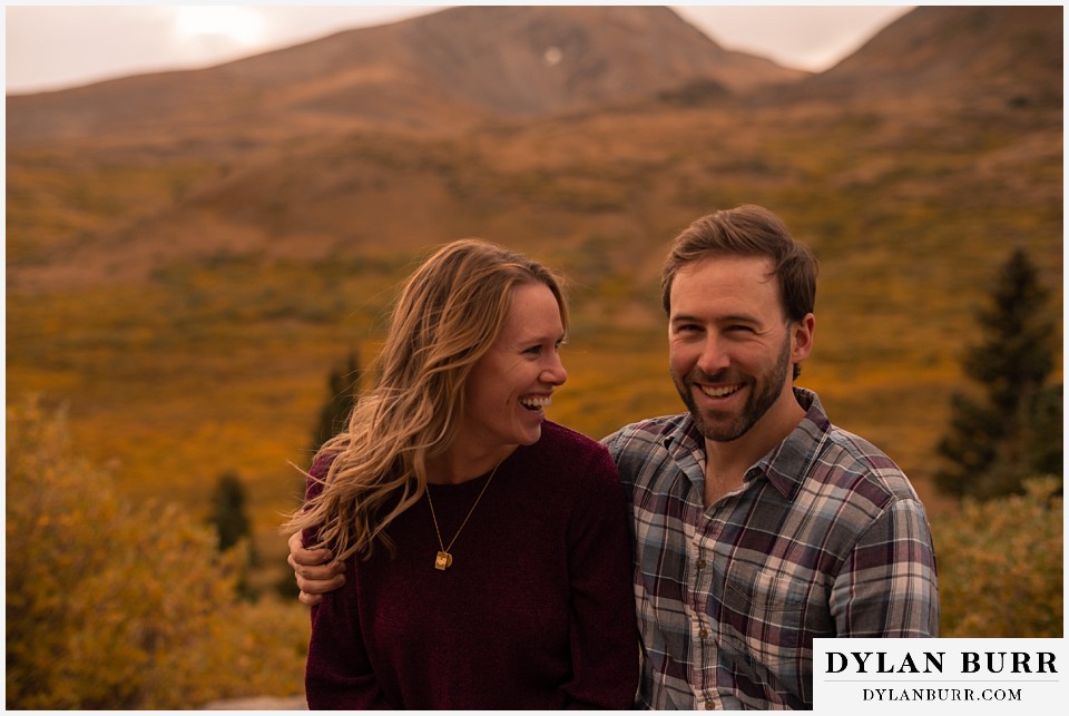fall engagement photos in colorado couple laughing together happy couples photos real emotions