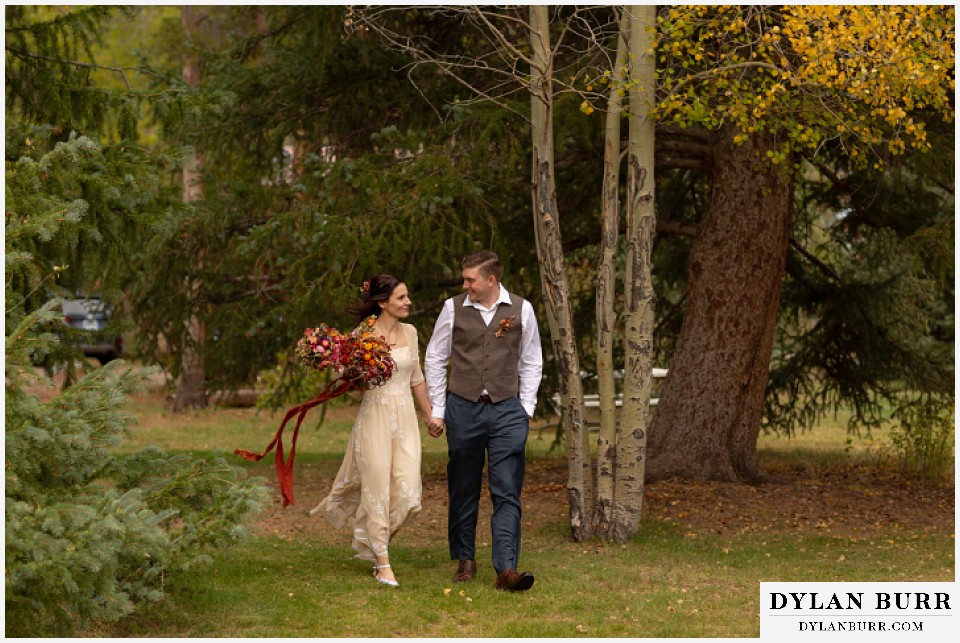 grand lake wedding elopement bride and groom walking through trees