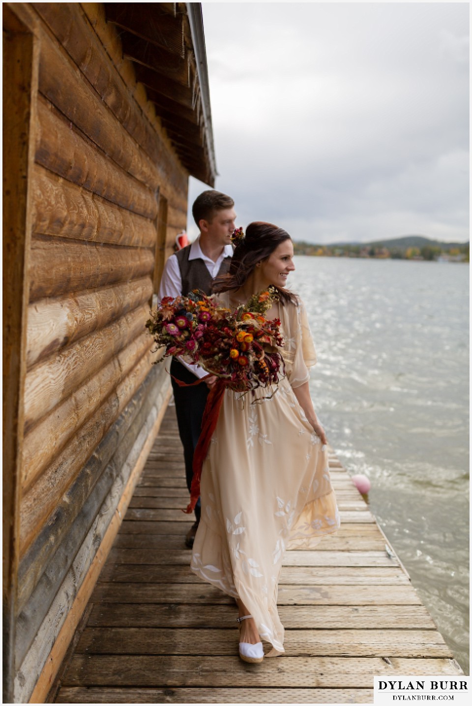grand lake wedding elopement bride and groom walking back to shore from boat house
