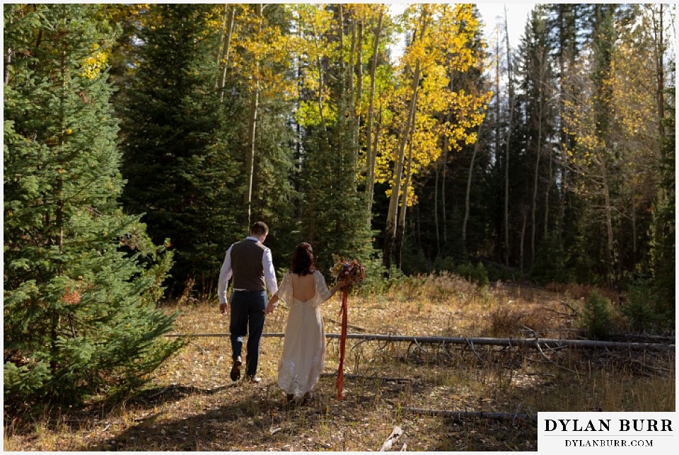 grand lake wedding elopement bride and groom walking into fall colors