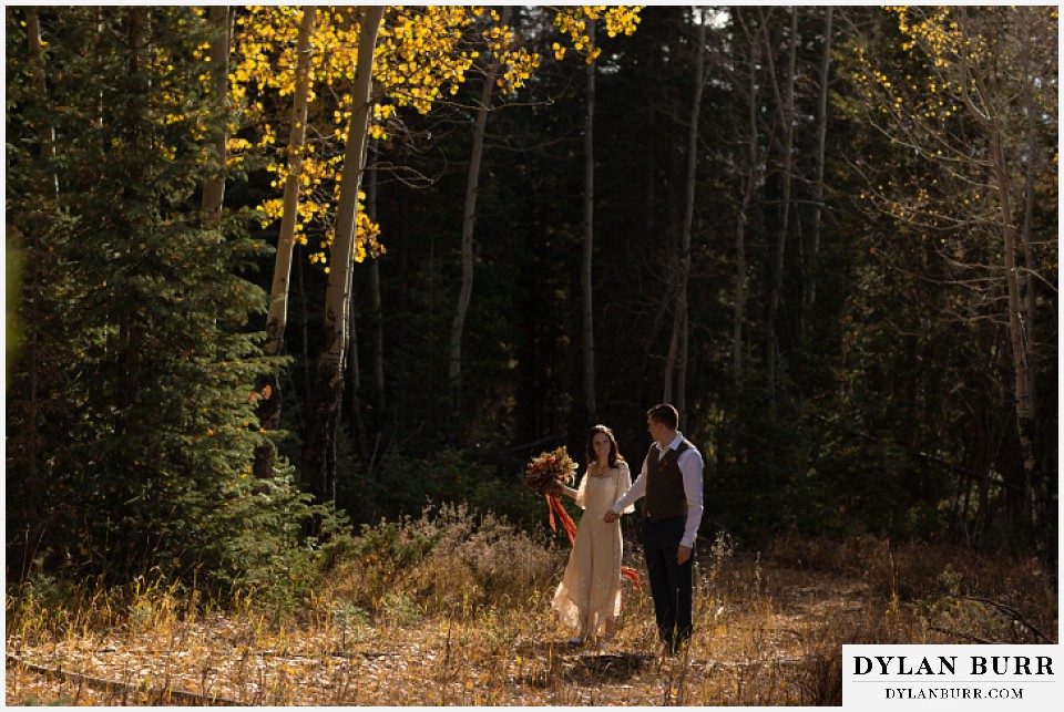 rocky mountain national park grand lake wedding elopement bride and groom walking in aspen trees