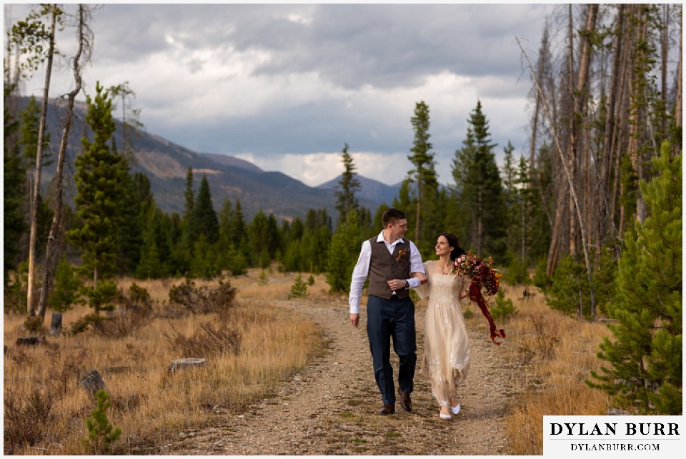 rocky mountain national park grand lake wedding elopement bride and groom walking in mountain valley