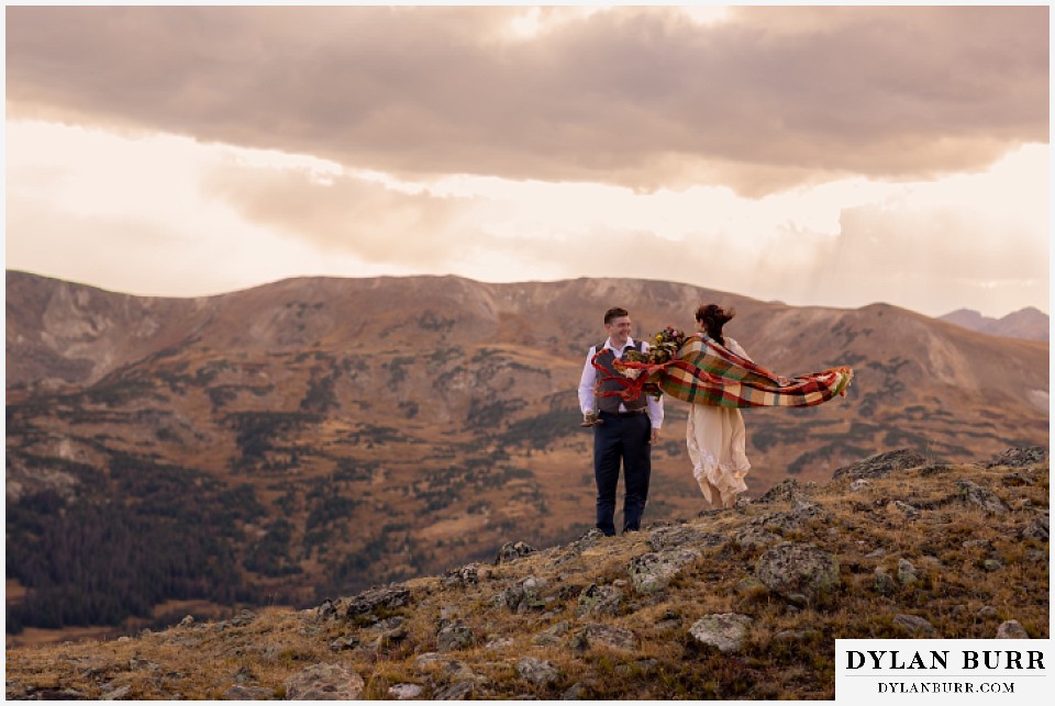 rocky mountain national park grand lake wedding elopement groom and bride with blanket blowing in the wind
