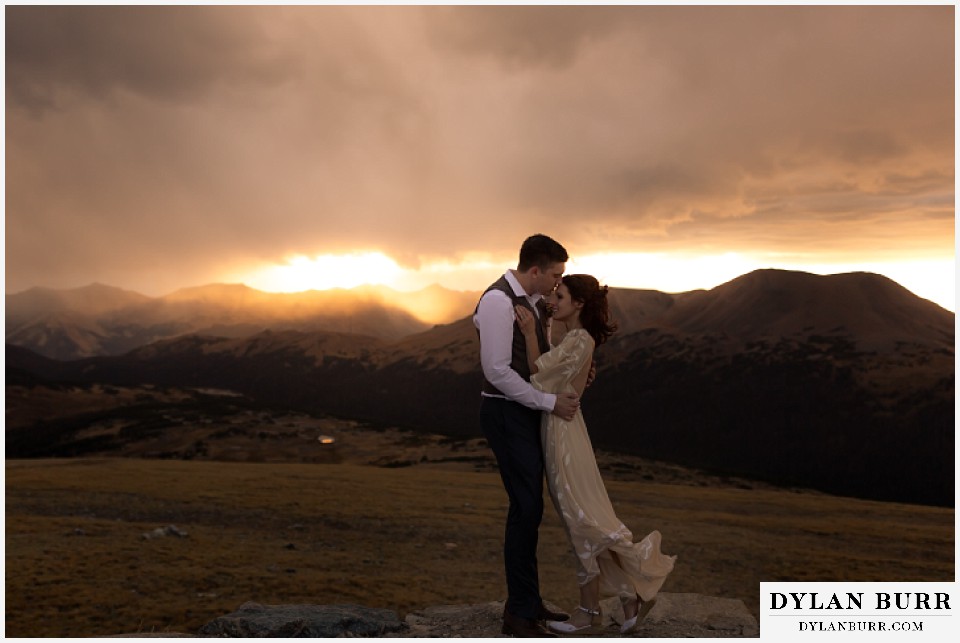 rocky mountain national park grand lake wedding elopement groom kissing brides forehead on sunset