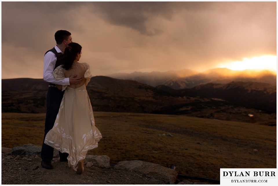 rocky mountain national park grand lake wedding elopement bride and groom holding each other on a mountain enjoying the sunset