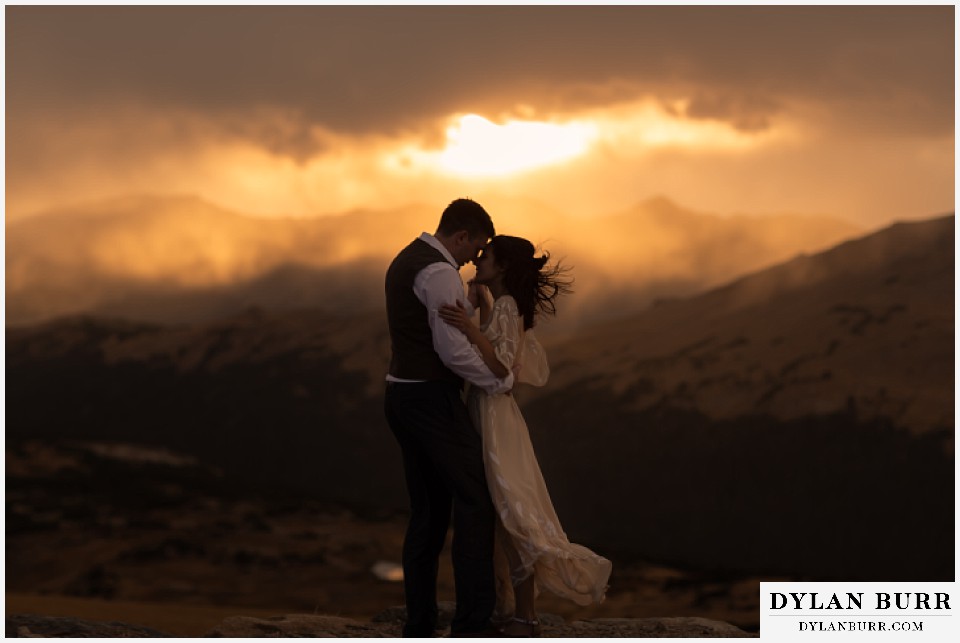 rocky mountain national park grand lake wedding elopement bride and groom snuggling up at sunset