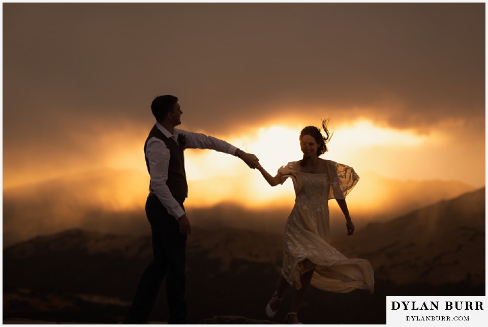 rocky mountain national park grand lake wedding elopement bride and groom dancing together in the sunset