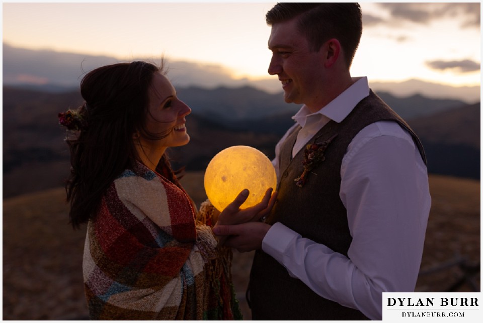 rocky mountain national park grand lake wedding elopement bride and groom holding moon during harvest moon