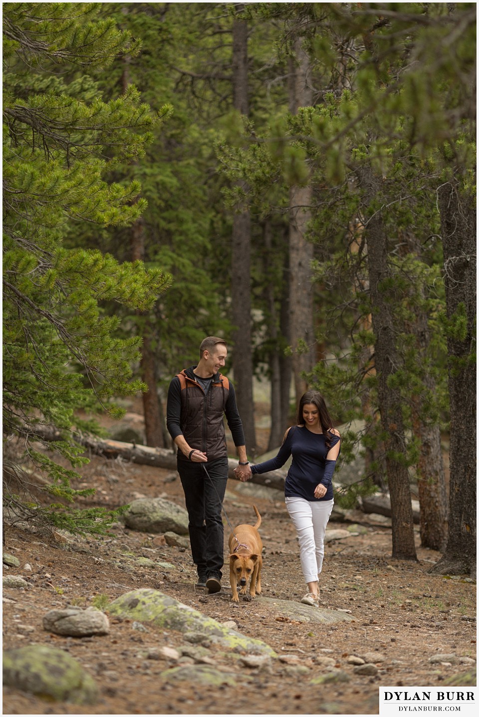 rocky mountain engagement session in colorado walking on trail
