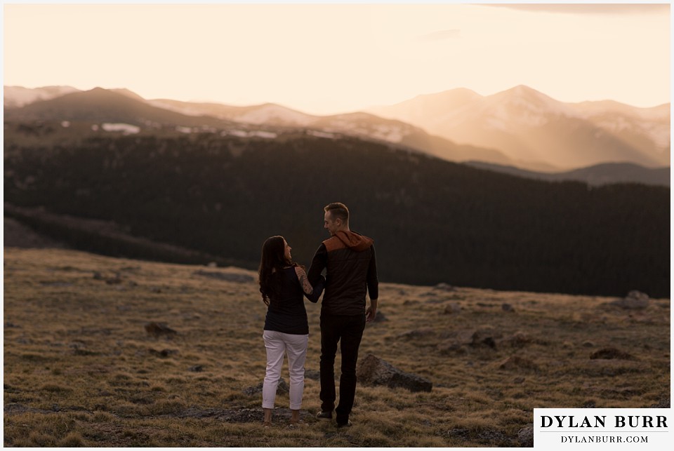 rocky mountain engagement session in colorado sunset cutting through mountains