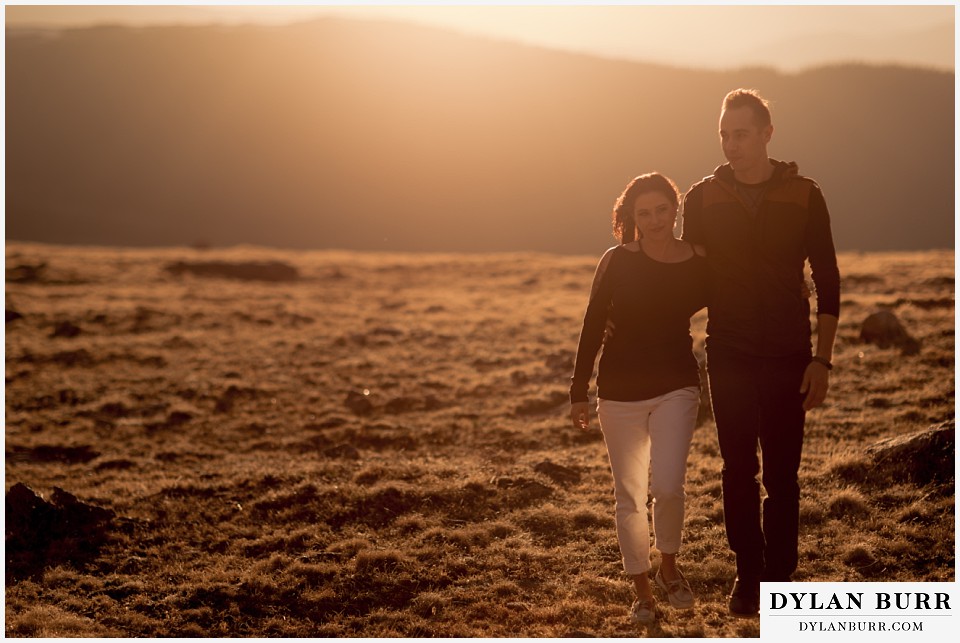rocky mountain engagement session in colorado walking together in sunset