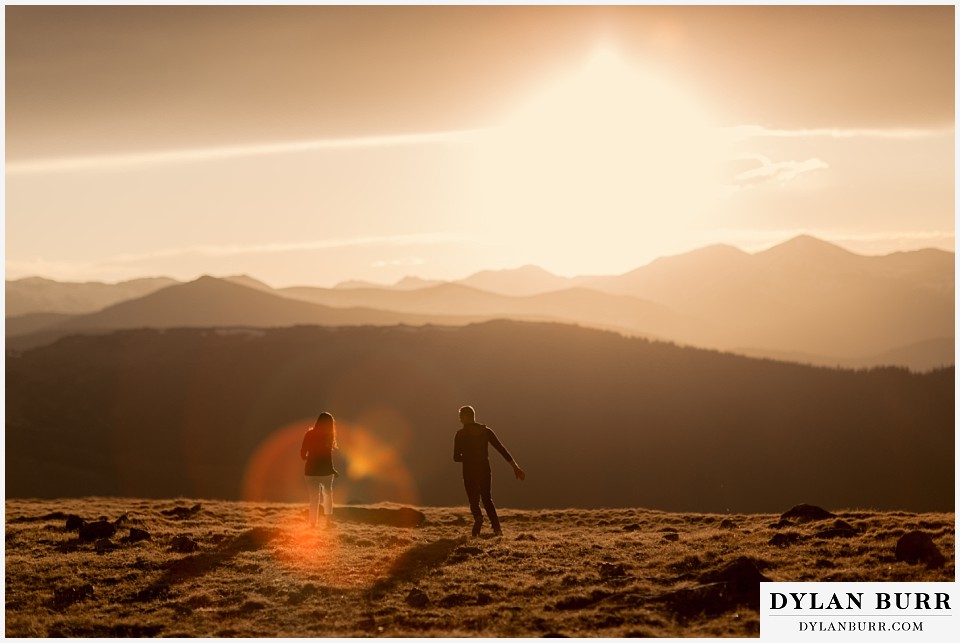 rocky mountain engagement session in colorado playing tag at sunset