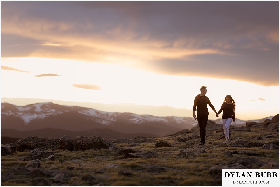 rocky mountain engagement session in colorado alpine trail with snow on top of mountains in background