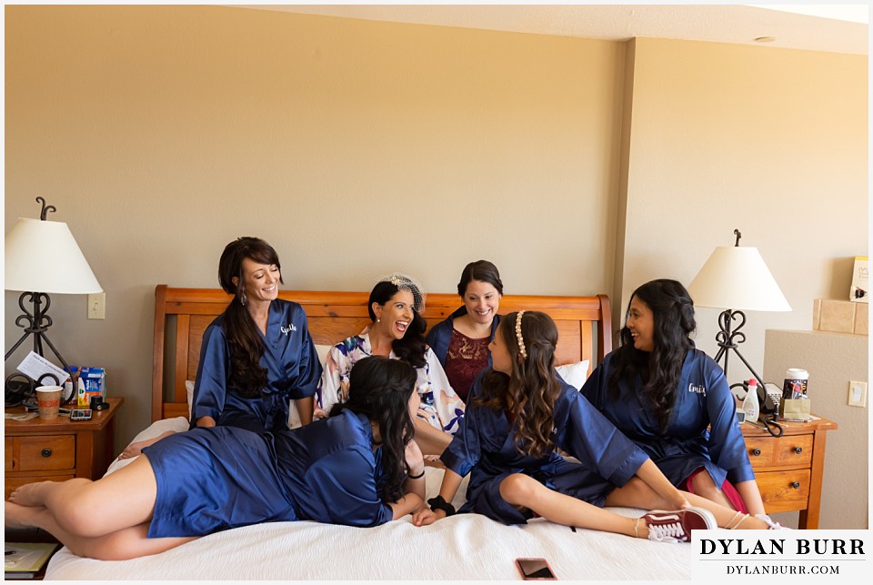 winter park mountain lodge wedding colorado bride and bridesmaids on bed in robes