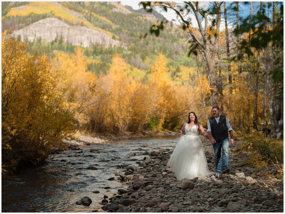 adventure elopement western colorado walking along river
