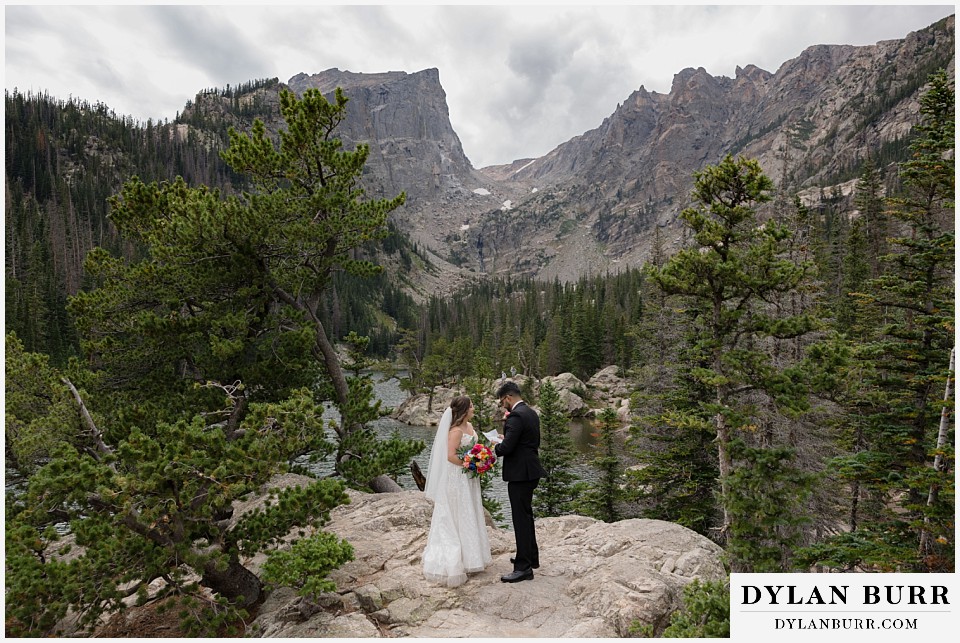 all day elopement in Rocky Mountain National Park reading letters to eachother