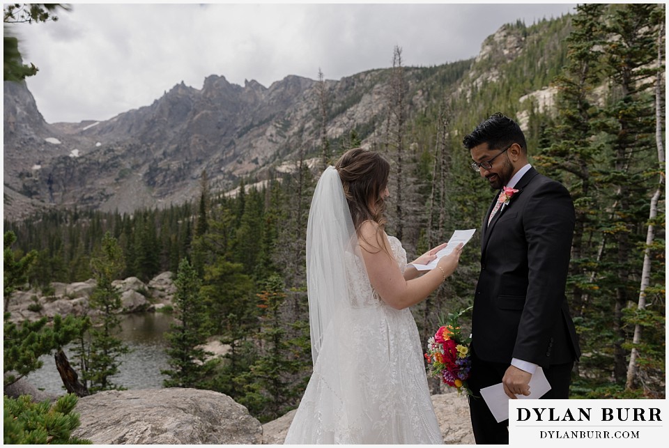 all day elopement in Rocky Mountain National Park bride reading a letter to her husband