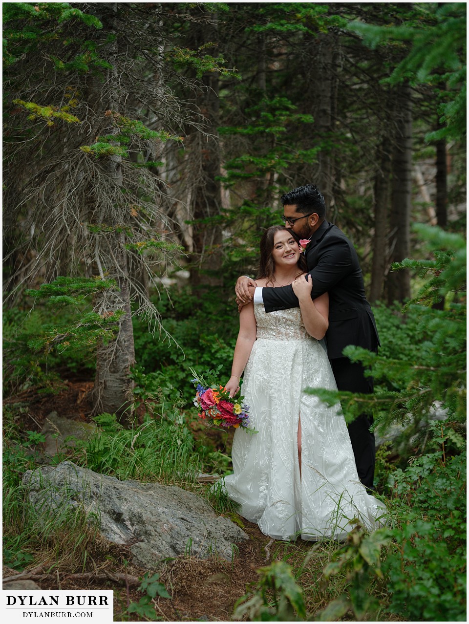 all day elopement in Rocky Mountain National Park couple together in the pine trees nuzzling