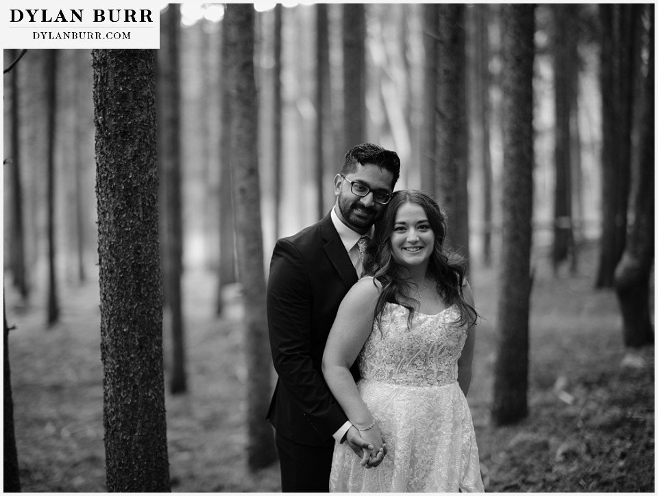 all day elopement in Rocky Mountain National Park black and white of newlywed couple in pine trees very classic looking