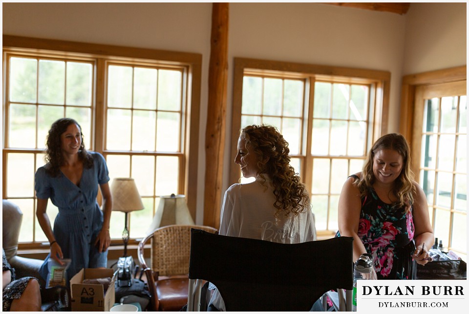 Bride with her embroidered robe while getting ready in granby co