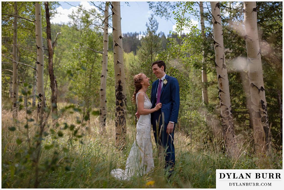 antler basin ranch wedding bride and groom laughing together in field