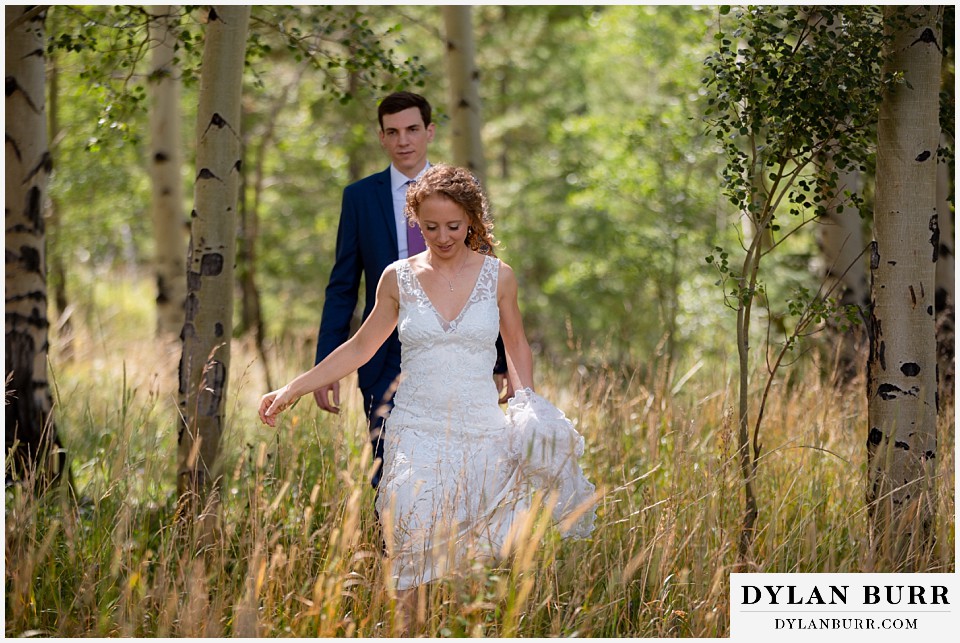 antler basin ranch wedding bride and groom walking in field