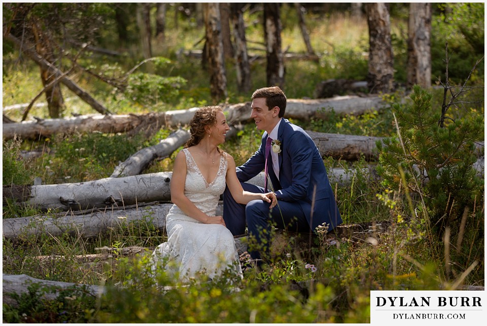 bride and groom laughing together in forest antler basin ranch wedding