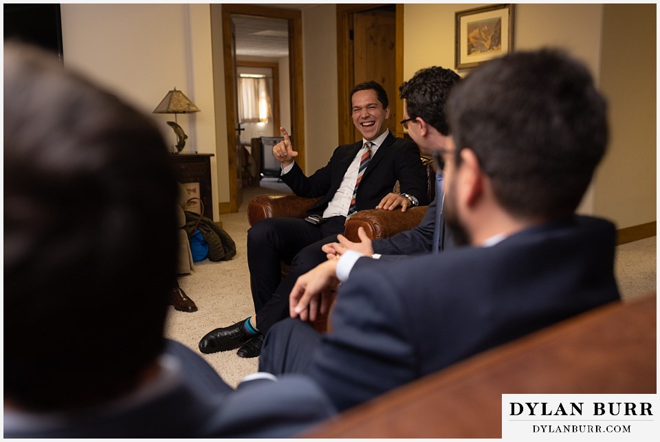 best man laughing telling a story during jewish tisch