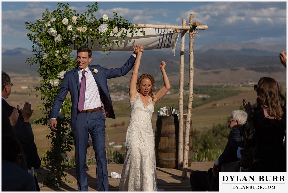 extremely happy bride and groom exiting ceremony Antler Basin Ranch wedding