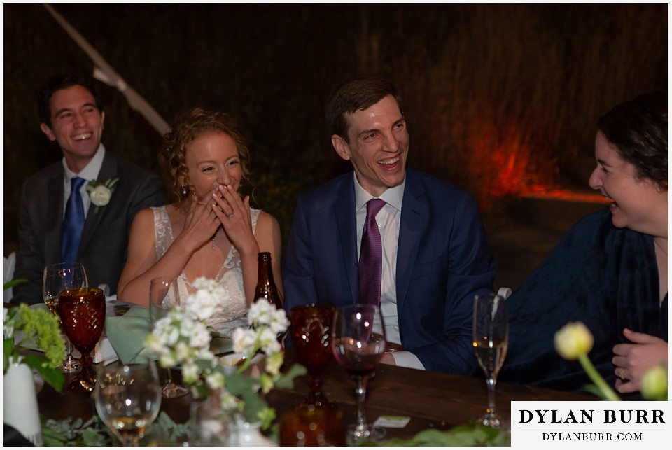bride and groom laughing hard during reception at Antler Basin Ranch wedding