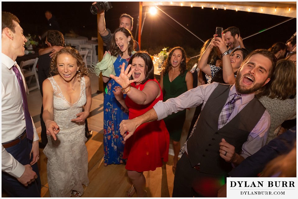 bride signing during reception at antler basin ranch wedding