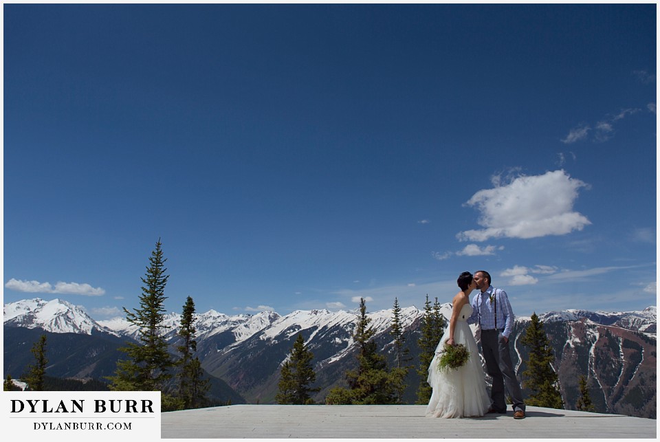 aspen wedding elopement bride and groom kissing with mountains in background