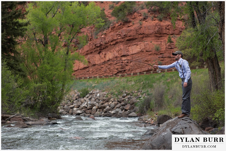 aspen wedding elopement groom standing on rock fly fishing