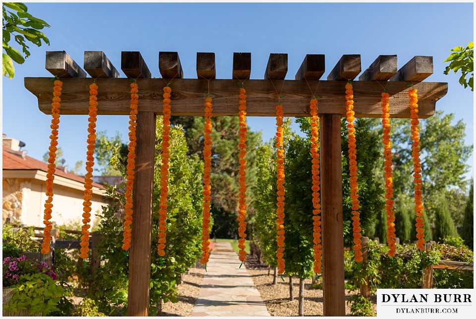 baldoria on the water wedding lakewood colorado hindu wedding orange flowers on a string