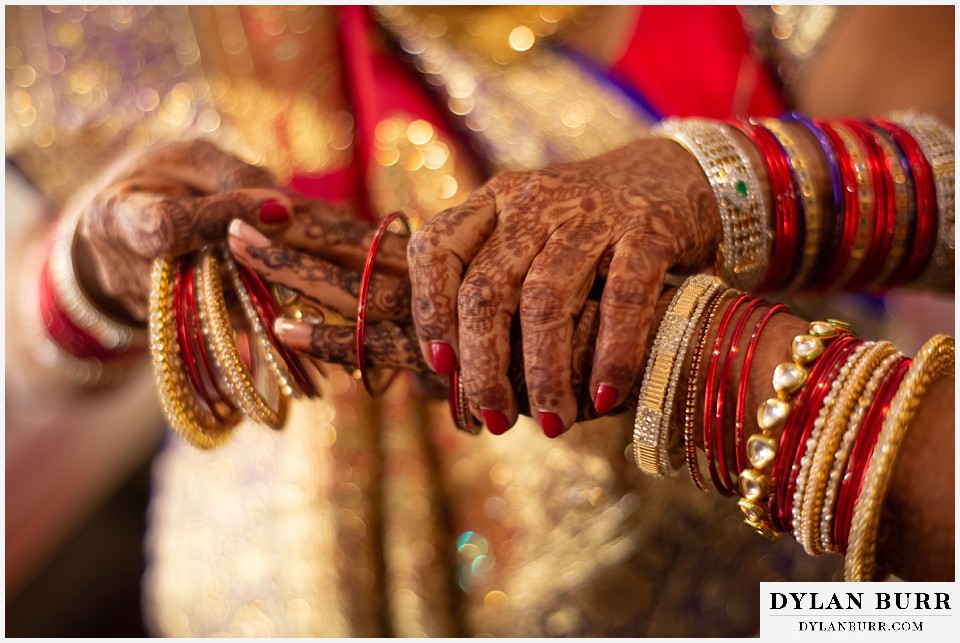 baldoria on the water wedding lakewood colorado hindu wedding bride putting bangles on