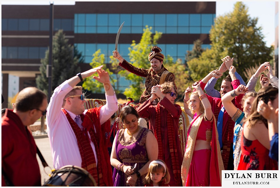 baldoria on the water wedding lakewood colorado hindu wedding groom riding on horse during baraat