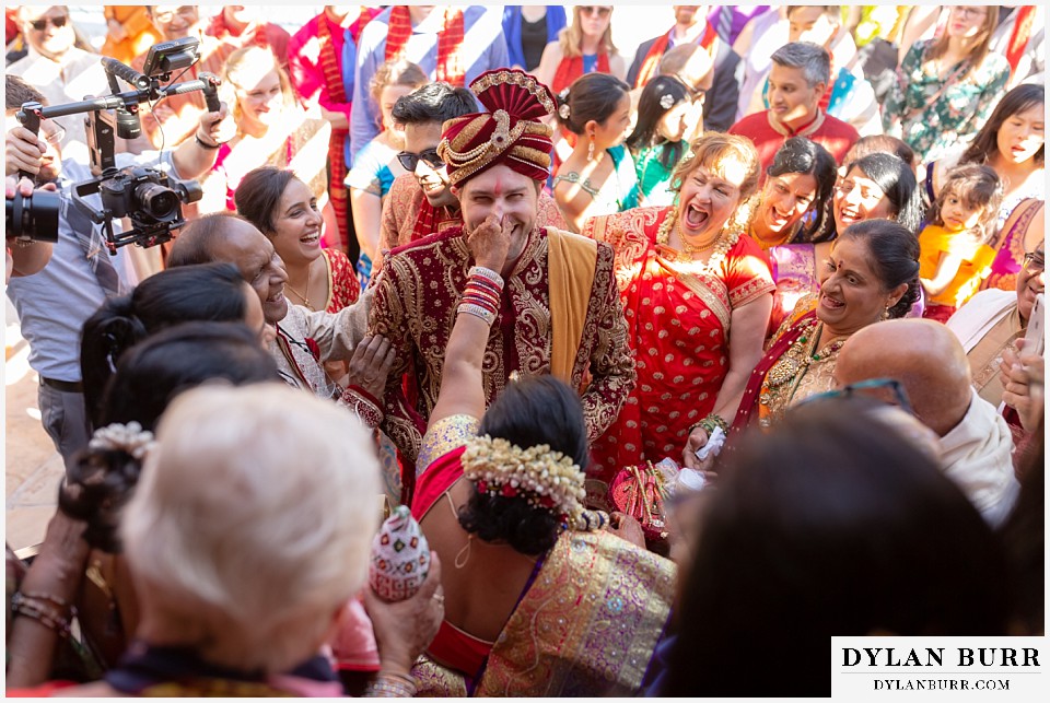 baldoria on the water wedding lakewood colorado hindu wedding groom being grabbed by brides mother