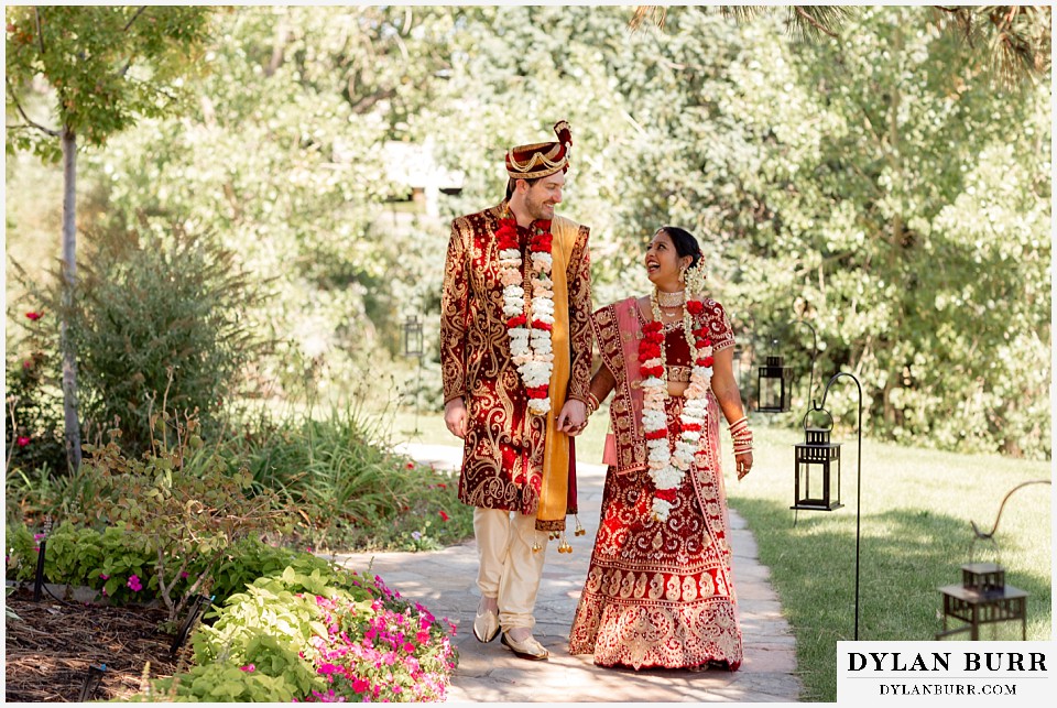 baldoria on the water wedding lakewood colorado hindu wedding bride and groom walking down path