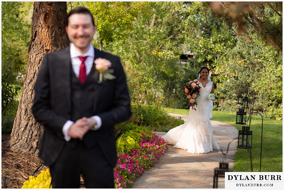 baldoria on the water wedding lakewood colorado hindu wedding bride walking up to groom during first look