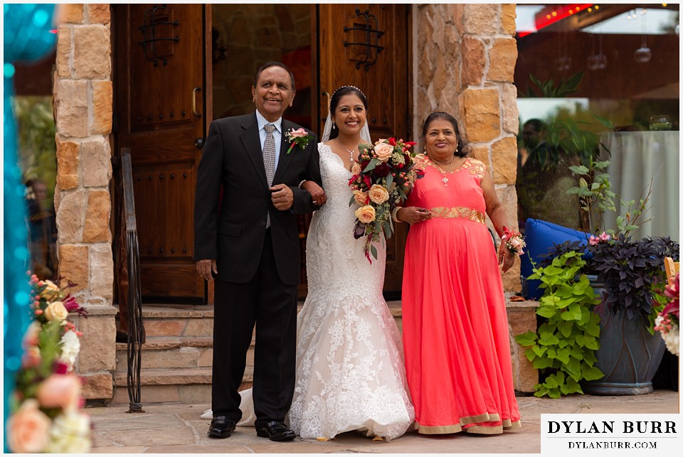 baldoria on the water wedding lakewood colorado hindu wedding bride walking down aisle with family