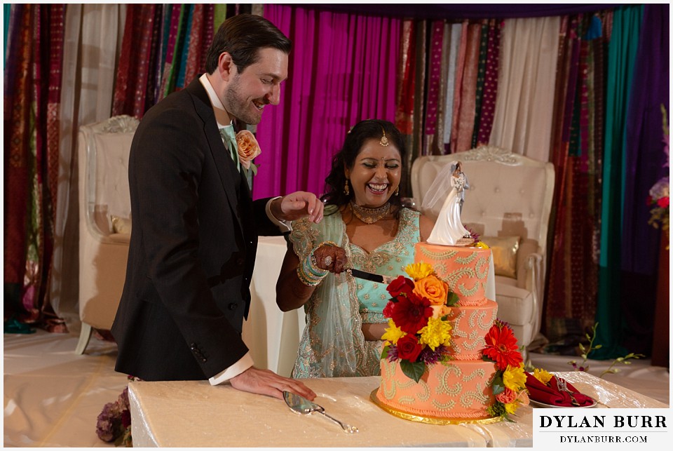 baldoria on the water wedding lakewood colorado hindu wedding bride and groom cutting cake